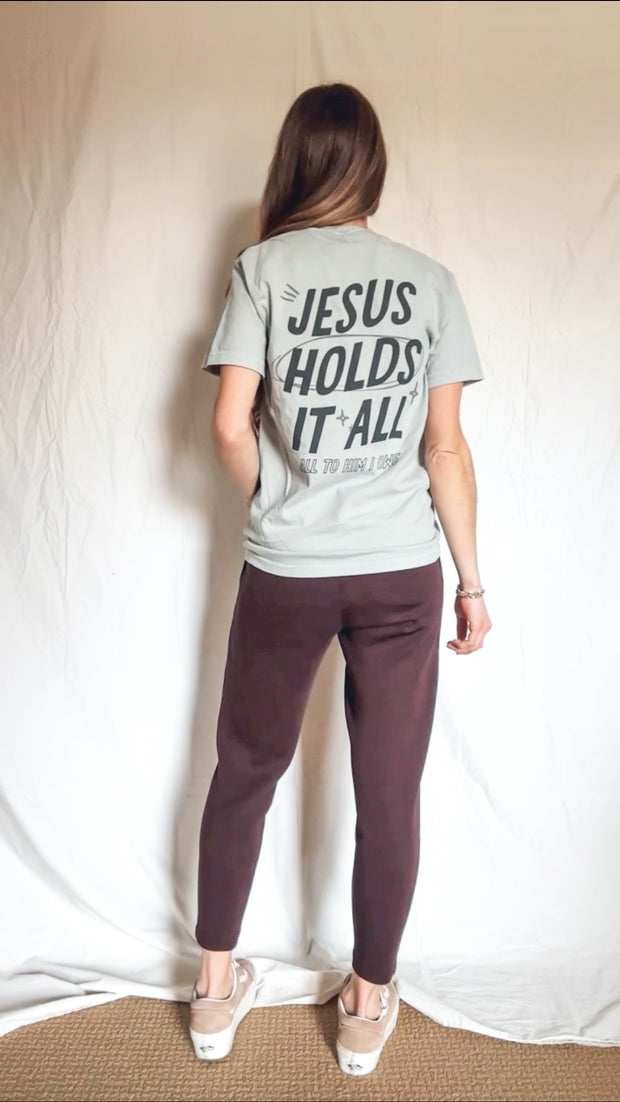 Jesus Holds It All Graphic Tee